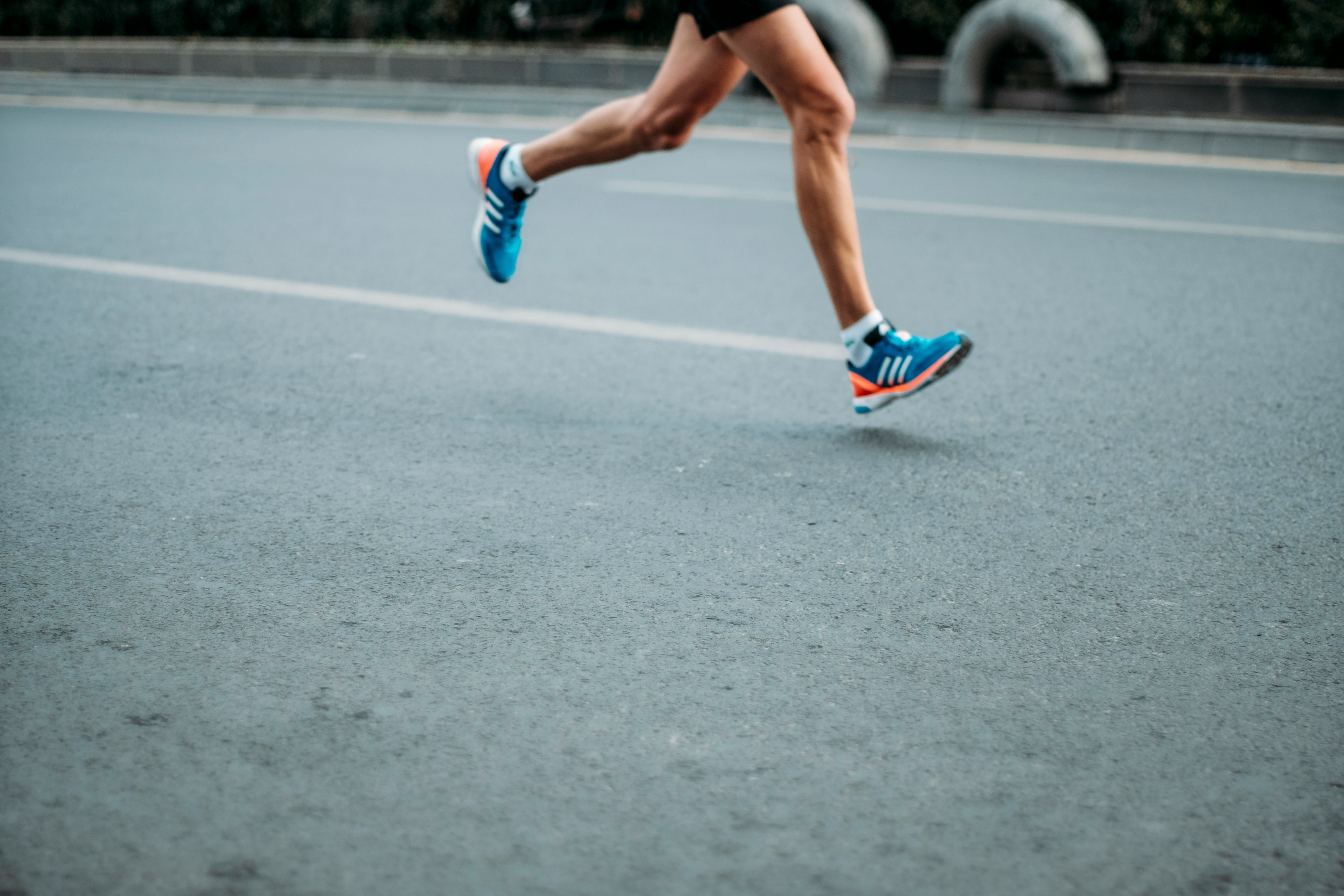 image of someone running on asphalt photo by sporlab