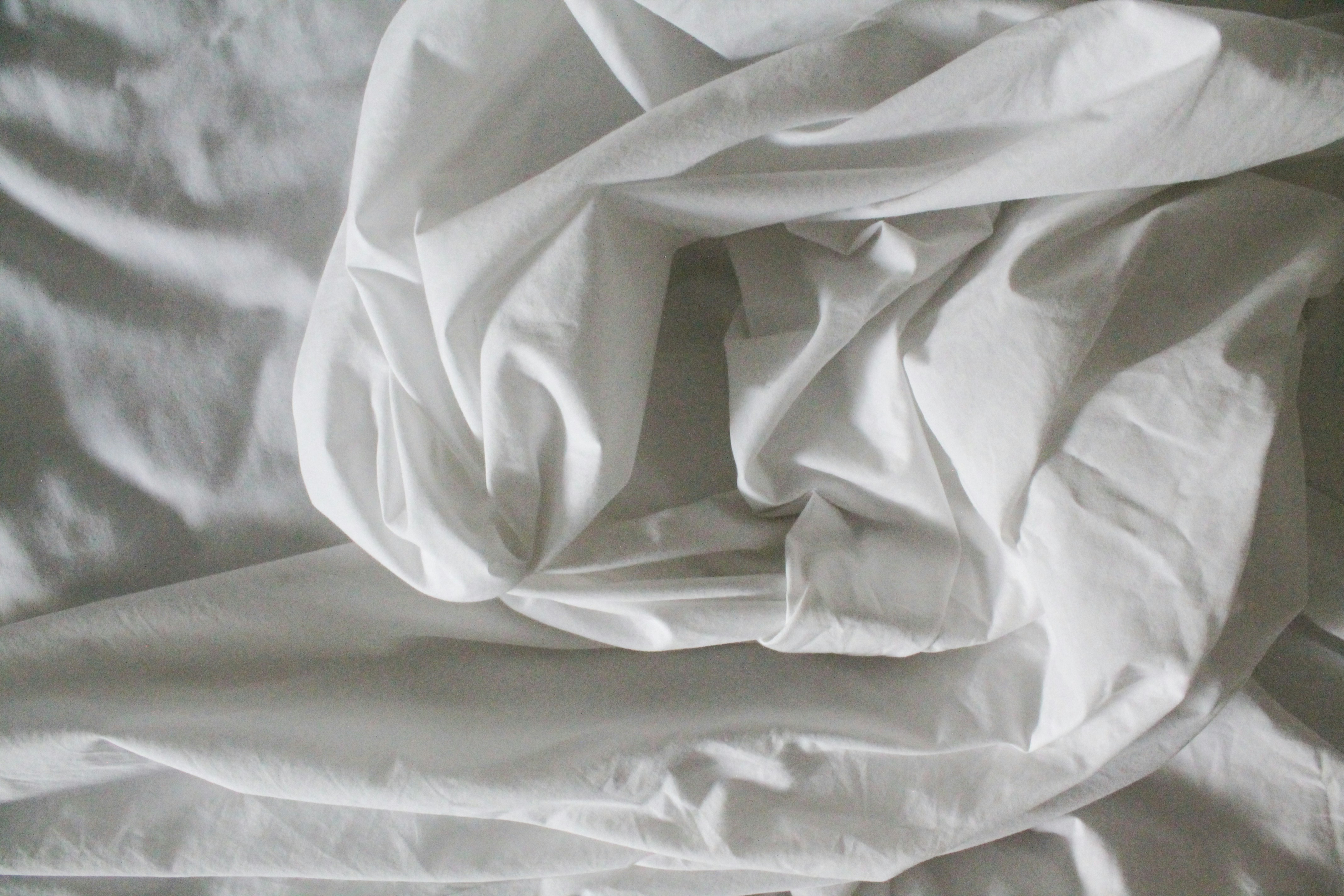 White crumpled sheets photo by Justine Camacho